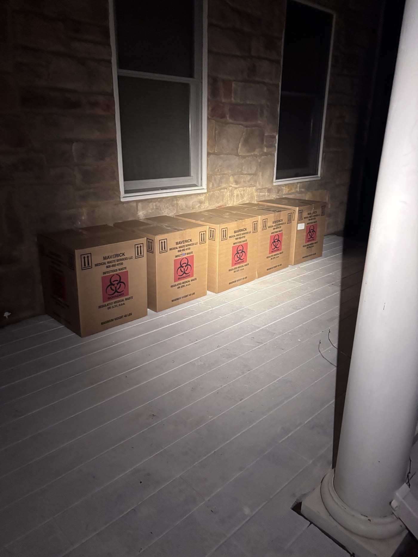 Regulated medical waste containers staged for licensed transport.